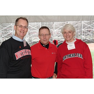 Marion Stanley, Vice President for University Corporate Partnerships, poses with two participants during Homecoming festivities