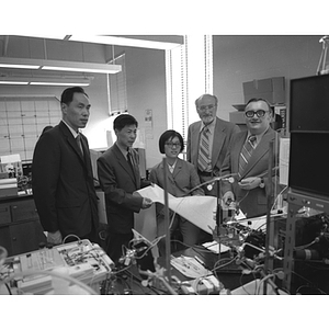 Barry Karger, Karl Weiss, and three unidentified Chinese scientists in a laboratory