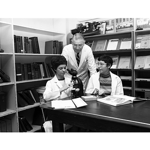 Professor and assistants from the Lincoln College program in chemical/biological technology conducting an experiment