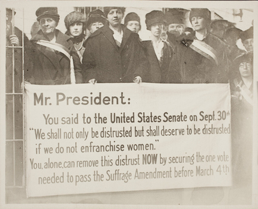 Suffragists with a protest banner during President Wilson's visit to Boston, Mass., Feb. 1919