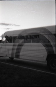 Free Spirit Press crew hanging out the windows of their bus (blurry)