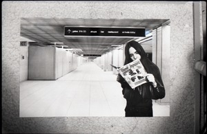 Heidi Bushell reading a copy of Free Spirit Press (vol. 1, 4) at the airport: manipulated copy print inserting image of airport in background