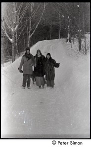 Elliot Blinder, Catherine Blinder, and unidentified woman (l. to r.) walking through heavy snow, Tree Frog Farm commune