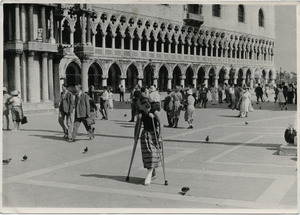 Pat Spaulding walking on crutches through the Piazza San Marco, Venice