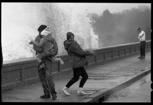 Judy Salonia, her husband Vincent, and daughter Ashley (4) dodge a wave crashing over the Narragansett seawall