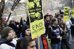 Justice for Jason rally at UMass Amherst: protesters carrying signs reading 'End hate crimes'