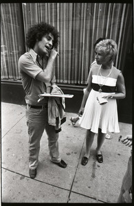 Abbie Hoffman talking to a woman on the street