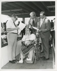 Woman in wheelchair and men on gangplank