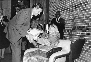 Mayor Raymond L. Flynn presenting proclamation to unidentified woman