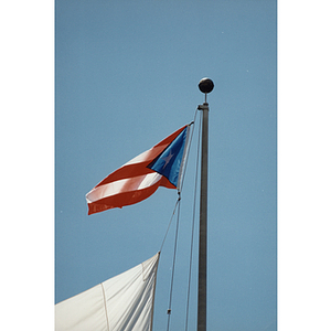 A Puerto Rican flag flies from a flagpole