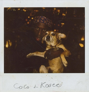 A Polaroid of Cocoa Rodriguez Holding a Small Dog