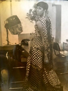 A Photograph of Marlow Monique Dickson Looking Back at the Camera in a Black and White Dress