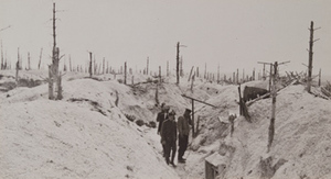 One soldier and three civilians standing in German trenches in snow-covered war-torn hillocks