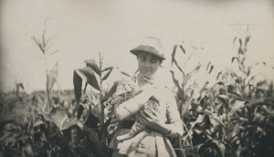 Miss Daisy Hayward holding cat in cornfield, at Falmouth