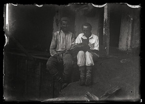 Joseph Obrebski: seated, holding a dog, next to a friend