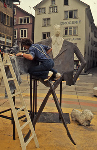 Sculptor working on installation
