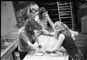 Sammy Wolf, Nick Carson, and Julie Howard, working in the commune bakery