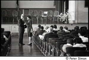 Man and woman talking in the aisle before commemorative service for Martin Luther King