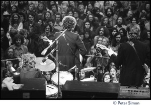 Bob Dylan performing on stage at the Boston Garden with The Band