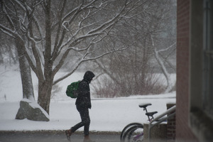 Student trudging through the snow, UMass Amherst, during his book event