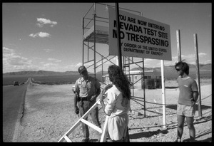 Peace encampment activists talking a security guard at the entrance to the Nevada Test Site