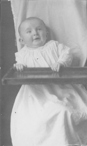 Edward Snow Willis sitting in a high chair