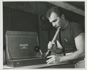 Man working on the case for an award plaque for Helen Keller