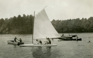 Harris Barnes' boat with three rowboats at Camp Coolidge