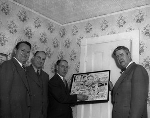 Three men posing with Thomas P. O'Neill and cartoon of Thomas P. O'Neill drawn by Joe Beesan