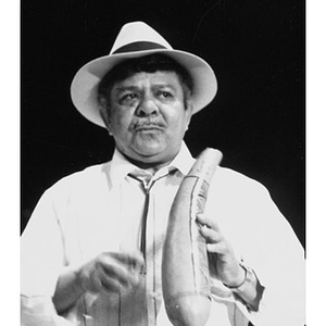 Man playing a güiro, a gourd scraper.