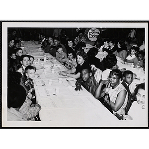 Women and boys sit at tables during a Mothers' Club banquet