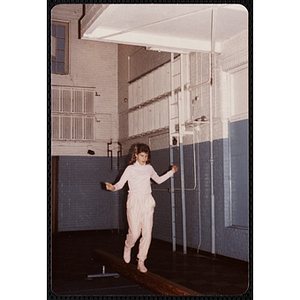 A girl walks along a balance beam at the Charlestown gymnasium