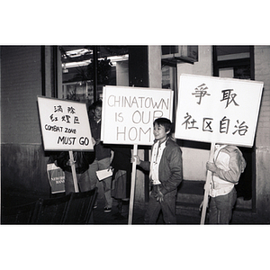 Protesters at an evening demonstration led by residents of Chinatown to take back their community from the Combat Zone, the red-light district in Boston