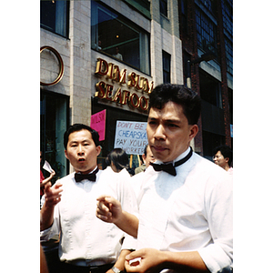Two male Dynasty Restaurant employees speak at a demonstration on Edinboro Street