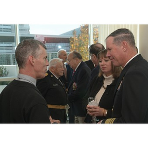 People converse at the Veterans Memorial dedication ceremony