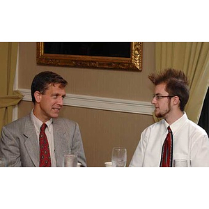 Jordan Munson converses with a man at the Torch Scholars Manganaro Luncheon