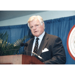 Senator Edward Kennedy at a podium at the Egan Research Center dedication ceremony