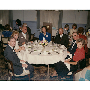 George and Lorraine Snell sitting with guests at dedication luncheon