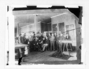 ___ at Albany [Group photo of men in an office]