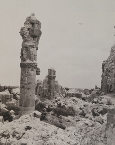 View of damaged columns sticking out of a pile of rubble