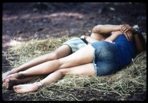 Couple embracing on the ground at the Woodstock Festival