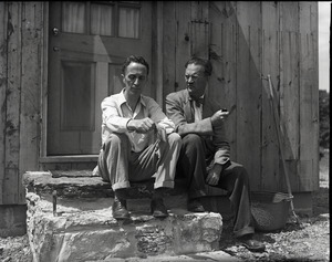 Norman Rockwell (left) and Alton Blackington seated on the steps of Rockwell's studio