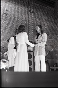 Wedding of Jim and Anne Baker: exchanging vows in front of minister and drum set