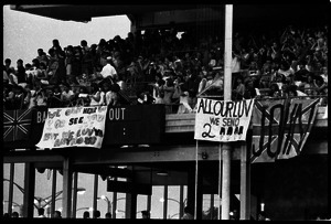 Beatles concert at Shea Stadium: Beatles fans packed in the upper deck, with banners reading 'We can't hear or see you, but we luv ya anyhow'