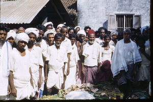 Men gather to have their photo taken in Mangadu
