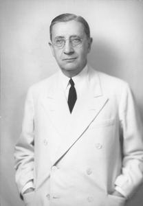 Frank L. Boyden standing with his hands in his pockets