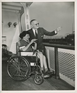 Woman in wheelchair and old man at boat rail