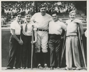 Babe Ruth posing with ICD clients at a baseball game