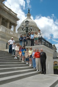 Congressman John W. Olver (far right) with visiting group, posed on the steps of the United States Capitol building