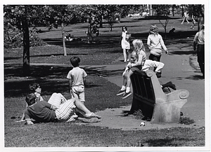 Adults and children around a bench in Boston Common
